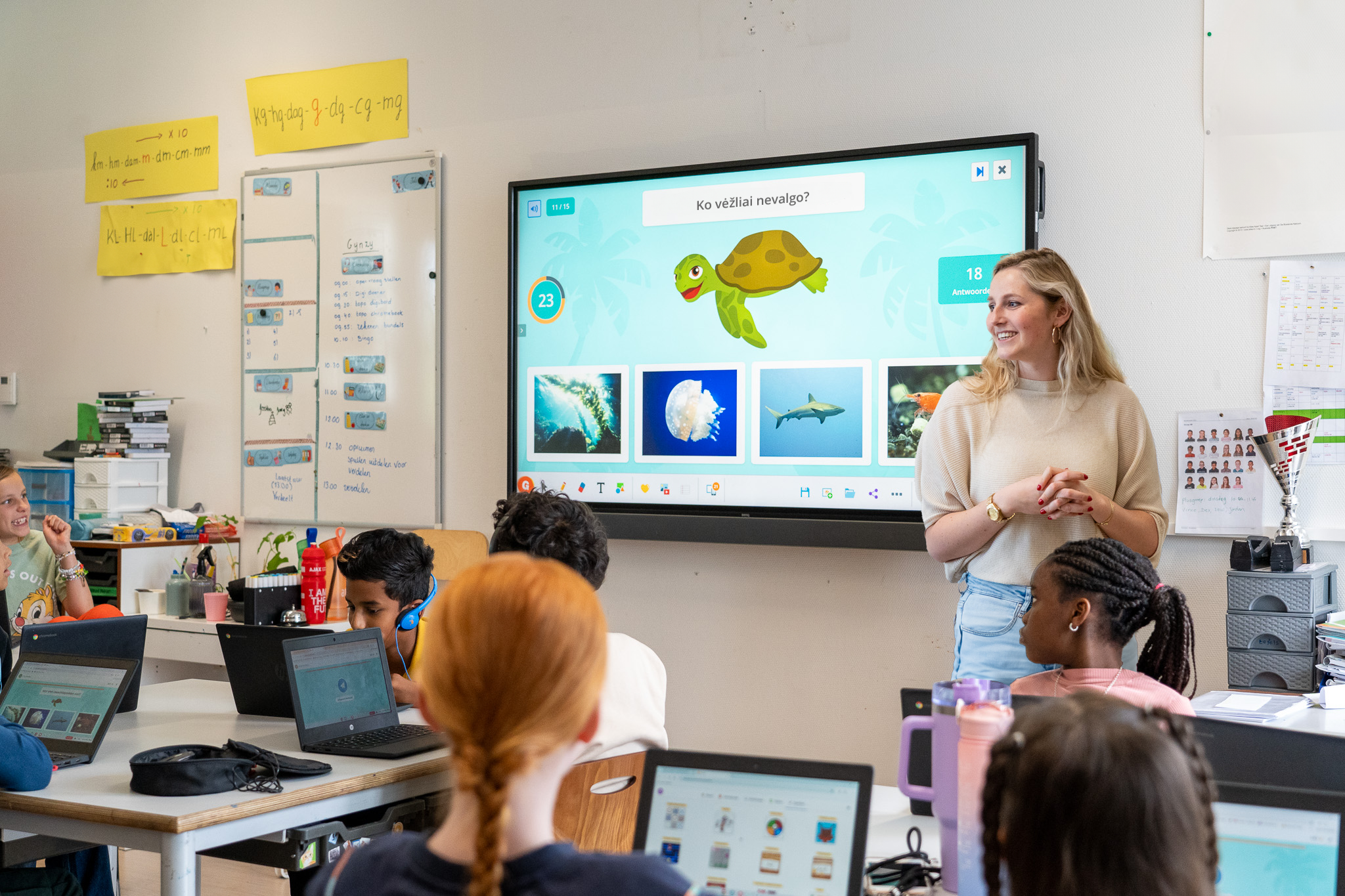 teacher standing in front of the class with classroom quiz